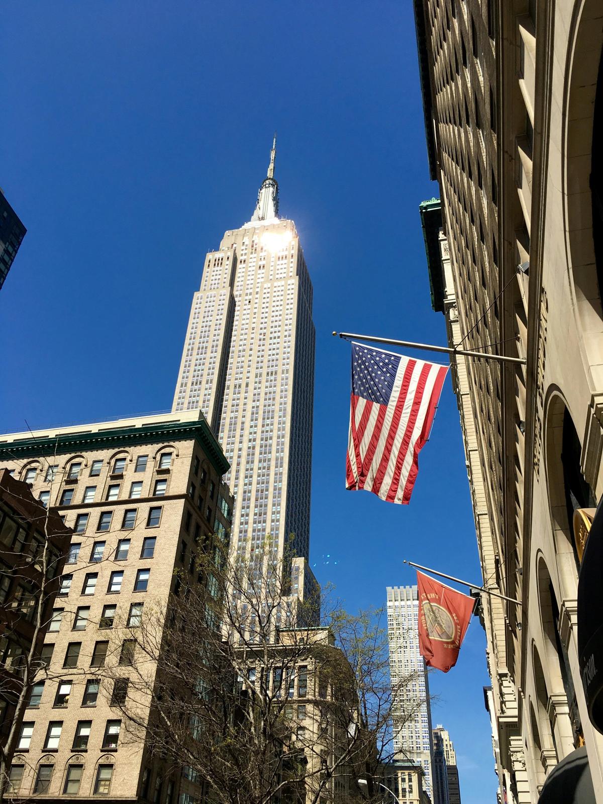 The Empire State Building and a United States flag in New York City