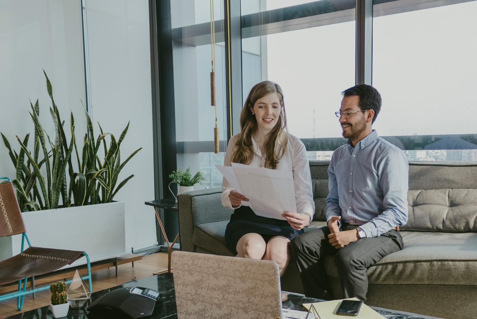 A Sekell adviser reviewing documents with a client in an office